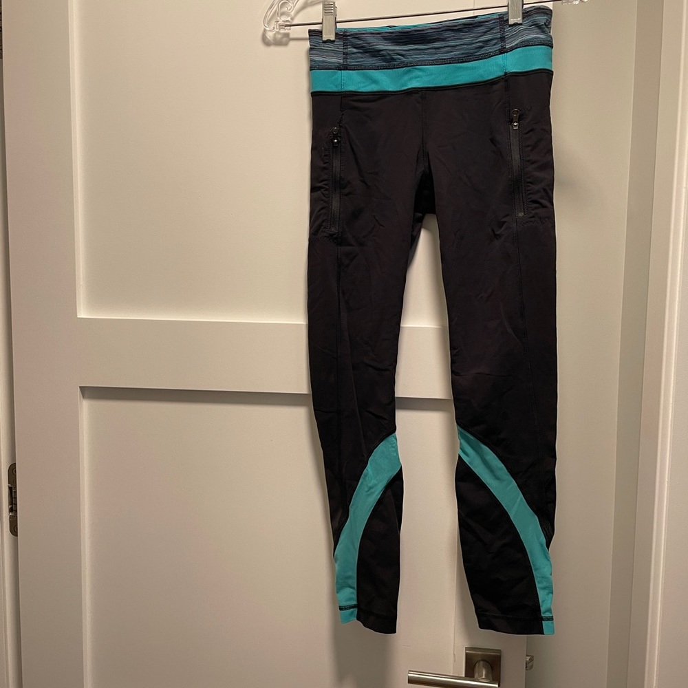 Lululemon black leggings with teal detailing. Size 4.